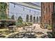 Outdoor patio with charming greenery, multiple seating arrangements and string lights at 908 Juniper Ne St # 205, Atlanta, GA 30309