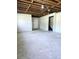 Spacious unfinished basement with a door and stairs at 5005 Dublin Dr, South Fulton, GA 30331