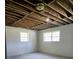 Unfinished basement with two windows and painted walls at 5005 Dublin Dr, South Fulton, GA 30331