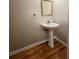 Powder room with pedestal sink and hardwood floors at 5005 Dublin Dr, South Fulton, GA 30331