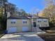 Two-story home with two-car garage and landscaping at 5005 Dublin Dr, South Fulton, GA 30331