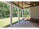 Covered back porch overlooking a wooded backyard at 1150 Sweet Mia Ln, Powder Springs, GA 30127