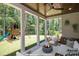 Covered patio with fire pit and playset overlooking a spacious backyard at 1150 Sweet Mia Ln, Powder Springs, GA 30127