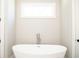 Bathroom with a free-standing bathtub at 1150 Sweet Mia Ln, Powder Springs, GA 30127