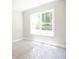 Bright bedroom with carpeted floor and large window at 1150 Sweet Mia Ln, Powder Springs, GA 30127