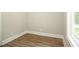 Simple bedroom with hardwood floors and a large window at 1150 Sweet Mia Ln, Powder Springs, GA 30127