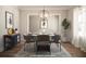 Bright dining room with chandelier and modern furnishings at 1150 Sweet Mia Ln, Powder Springs, GA 30127
