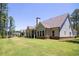 House exterior with a spacious backyard and covered patio at 1150 Sweet Mia Ln, Powder Springs, GA 30127