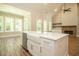 Kitchen island with farmhouse sink and views into the Gathering room at 1150 Sweet Mia Ln, Powder Springs, GA 30127