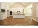 Open kitchen boasts white cabinets, an island, and hardwood floors at 1150 Sweet Mia Ln, Powder Springs, GA 30127