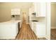 Long view of kitchen with white cabinets and hardwood floors at 1150 Sweet Mia Ln, Powder Springs, GA 30127