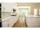 Modern kitchen with white cabinets, gas range, and quartz countertops at 1150 Sweet Mia Ln, Powder Springs, GA 30127
