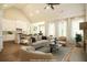 Open living room features vaulted ceilings, a kitchen, and a stone fireplace at 1150 Sweet Mia Ln, Powder Springs, GA 30127