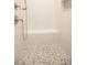 Modern shower with a built-in seat and pebble tile floor at 1150 Sweet Mia Ln, Powder Springs, GA 30127
