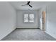 Bedroom with neutral carpet, a ceiling fan, and a window overlooking the neighborhood at 4090 Sandy Lake Dr, Stonecrest, GA 30038