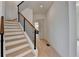 Inviting staircase features wood treads, white risers, and modern black metal railings at 4090 Sandy Lake Dr, Stonecrest, GA 30038