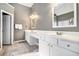 Spacious bathroom featuring dual sinks with white cabinets and a large mirror at 1120 Constitution Way, Cumming, GA 30040