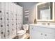 Cozy bathroom featuring a shower with a floral curtain and a white vanity at 1120 Constitution Way, Cumming, GA 30040