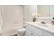 Bright bathroom featuring a tub-shower combo and a white vanity with elegant fixtures at 1120 Constitution Way, Cumming, GA 30040