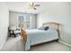 Cozy bedroom with a chair, natural light from a window, and comfortable bed at 1120 Constitution Way, Cumming, GA 30040