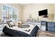 Bright bedroom with a large window and a comfortable bed and tv at 1120 Constitution Way, Cumming, GA 30040