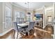 Charming dining room with hardwood floors, picture window, and stylish furnishings at 1120 Constitution Way, Cumming, GA 30040