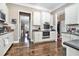 Spacious kitchen with stainless steel appliances, white cabinets, and a view into the dining room at 1120 Constitution Way, Cumming, GA 30040