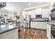 Bright kitchen featuring stainless steel appliances, white cabinets, and hardwood floors at 1120 Constitution Way, Cumming, GA 30040