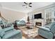 Spacious living room with a fireplace, hardwood floors, and ample seating at 1120 Constitution Way, Cumming, GA 30040