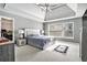 Serene bedroom with a tray ceiling, large windows, and plush carpeting at 1120 Constitution Way, Cumming, GA 30040