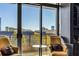 Condo balcony offers a relaxing spot with two comfortable chairs and city views at 750 Park Ne Ave # 8E, Atlanta, GA 30326