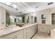 Luxurious bathroom with double sinks, marble countertops, and separate glass shower at 750 Park Ne Ave # 8E, Atlanta, GA 30326