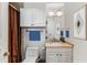 Cozy bathroom featuring white cabinets, a warm vanity top, and a neutral tiled wall at 750 Park Ne Ave # 8E, Atlanta, GA 30326