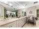 Luxurious bathroom featuring double sinks, ample counter space, decorative mirrors, and elegant fixtures at 750 Park Ne Ave # 8E, Atlanta, GA 30326