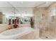 Bright bathroom with a soaking tub and glass enclosed shower at 750 Park Ne Ave # 8E, Atlanta, GA 30326