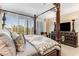 Bright bedroom features a four-poster bed with large windows, offering stunning views at 750 Park Ne Ave # 8E, Atlanta, GA 30326