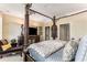 Beautiful bedroom with a four-poster bed, dark wood furniture and a cozy sitting area at 750 Park Ne Ave # 8E, Atlanta, GA 30326