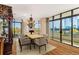 Dining area with a large wooden table, seating for eight, and floor to ceiling windows at 750 Park Ne Ave # 8E, Atlanta, GA 30326