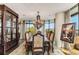 Formal dining room features stylish chandelier, large window, and dark wood table at 750 Park Ne Ave # 8E, Atlanta, GA 30326