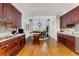 Gourmet kitchen leading to dining space, featuring cherry cabinets and granite countertops at 750 Park Ne Ave # 8E, Atlanta, GA 30326