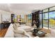 Open-concept living room with city views, built-in shelving, and comfortable seating area at 750 Park Ne Ave # 8E, Atlanta, GA 30326