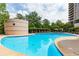 Large community pool surrounded by lush landscaping and featuring lounge chairs at 750 Park Ne Ave # 8E, Atlanta, GA 30326