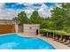 Refreshing community pool with inviting cool water, lounge chairs, and a trellised walkway at 750 Park Ne Ave # 8E, Atlanta, GA 30326
