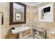 Stylish powder room with designer mirror, patterned walls, and a mirrored side table at 750 Park Ne Ave # 8E, Atlanta, GA 30326