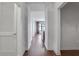 Bright hallway with hardwood floors and white walls at 565 Peachtree Ne St # 1509, Atlanta, GA 30308