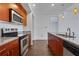 Modern kitchen with stainless steel appliances and wood cabinets at 565 Peachtree Ne St # 1509, Atlanta, GA 30308
