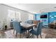 Modern dining room with blue accent wall and hardwood floors at 248 Hamilton Pointe Dr, Mcdonough, GA 30253