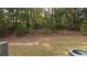 View of backyard with trees and lawn at 420 Berckman Nw Dr, Lilburn, GA 30047