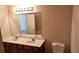 Bathroom with double sinks, lighted vanity mirror, and toilet at 420 Berckman Nw Dr, Lilburn, GA 30047