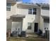 Rear view of house with AC units and patio at 420 Berckman Nw Dr, Lilburn, GA 30047